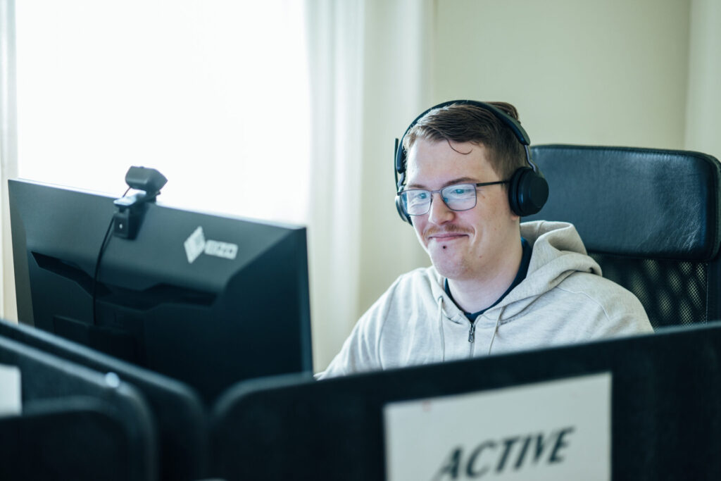 Medarbetare med headset som arbetar vid en datorskärm på Active IT